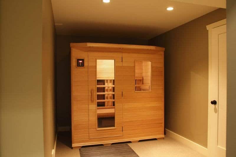 Compact infrared sauna in a home setting, blending seamlessly with modern home décor while offering health benefits.