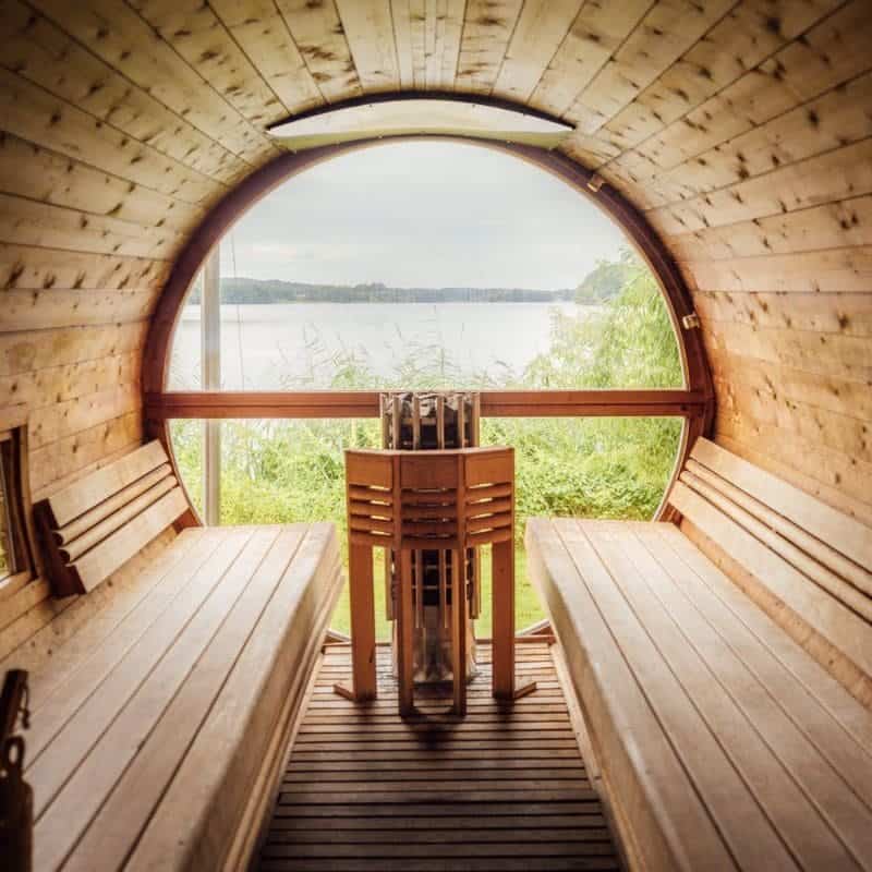 Lakeside traditional wooden sauna with a panoramic view, a tranquil setting for relaxation and rejuvenation after physical exercise
