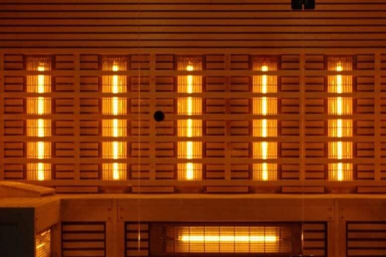 Warm glow of an infrared sauna interior with illuminated panels, a serene setting to discuss how long to see benefits of infrared sauna.