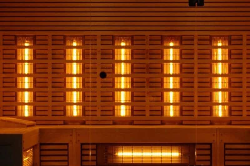 Warm glow of an infrared sauna interior with illuminated panels, a serene setting to discuss how long to see benefits of infrared sauna.