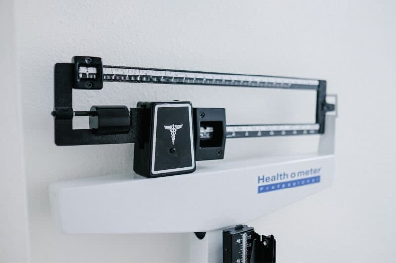 A professional balance weight scale, used for tracking weight management progress, often associated with regular infrared sauna use.