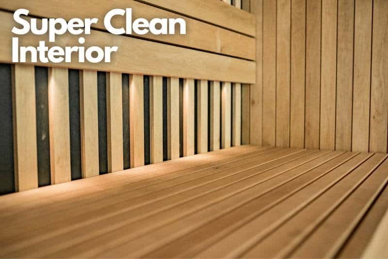 Super clean interior of a sauna with spotless wood benches and a bright atmosphere, perfect for showing someone how to clean a sauna properly.