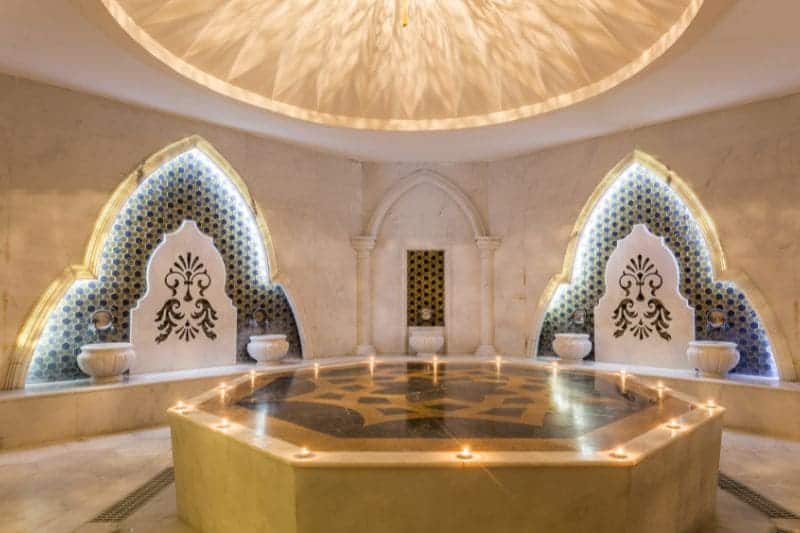 Luxurious Turkish bath with ornate mosaic designs, offering a tranquil setting for therapeutic heat treatments.
