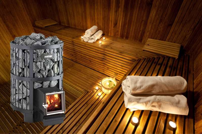 Close-up view of the Harvia Legend 240SL wood burning sauna stove with a glowing fire visible through the stove door. The sauna's wooden interior is warmly illuminated, reflecting the stove’s rustic and robust design.