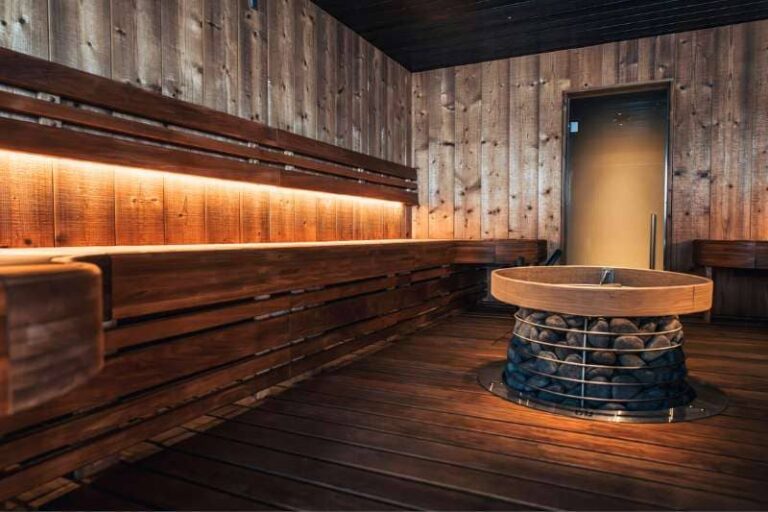 Modern sauna design featuring ambient lighting and stone heater