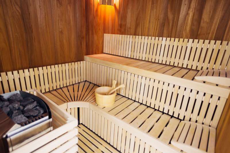 Close-up of sauna benches with a slatted design for improved comfort and heat distribution.