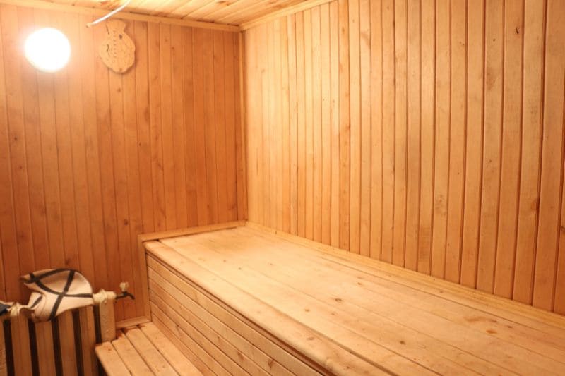 A compact sauna with wooden benches and walls, ideal for smaller homes or limited spaces.