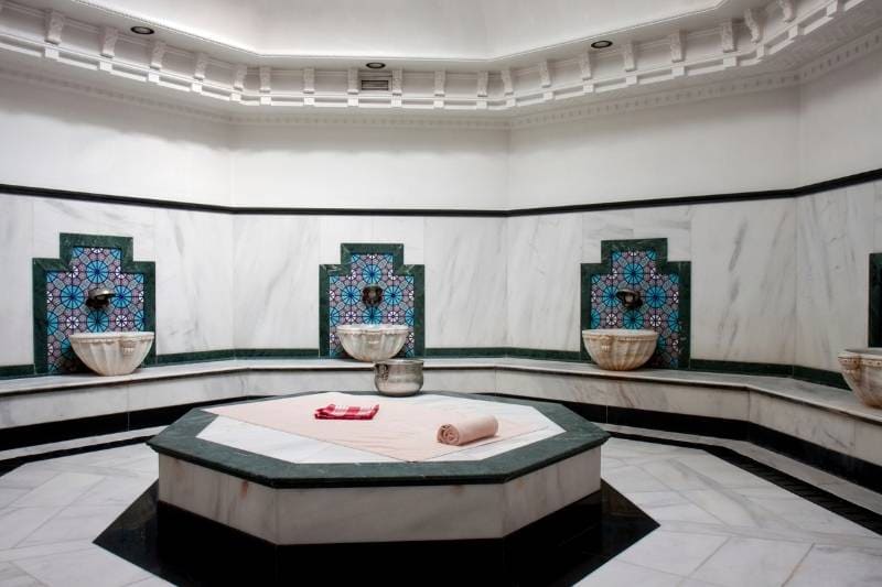 Ornate Traditional Turkish Hammam Bath Featuring Intricate Tile Patterns and Marble Basins, Reflecting the Historical Bathing Practices and Cultural Heritage of the Region.