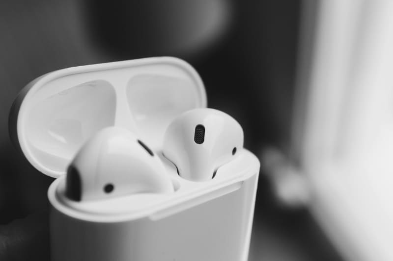 Close-up of white AirPods in an open charging case