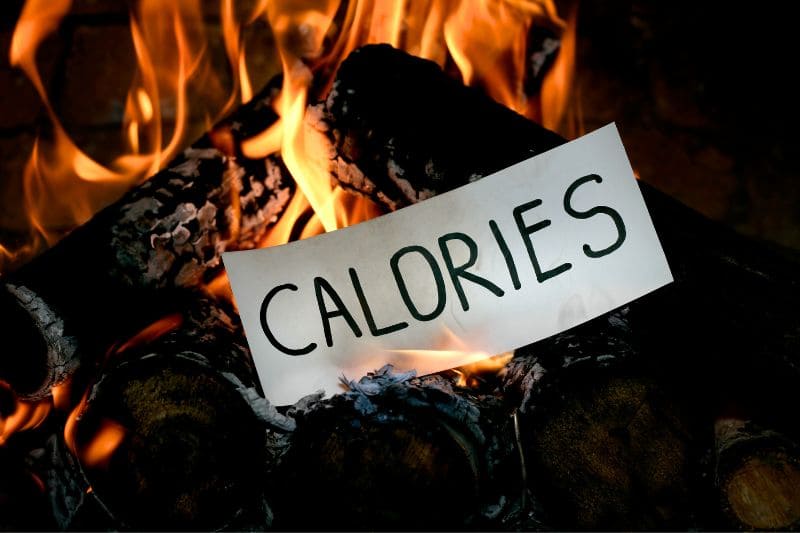 Calories" sign burning in flames, symbolizing metabolism boost and fat burning