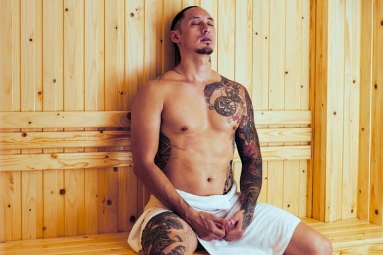 Man relaxing after sauna exercise in wooden sauna