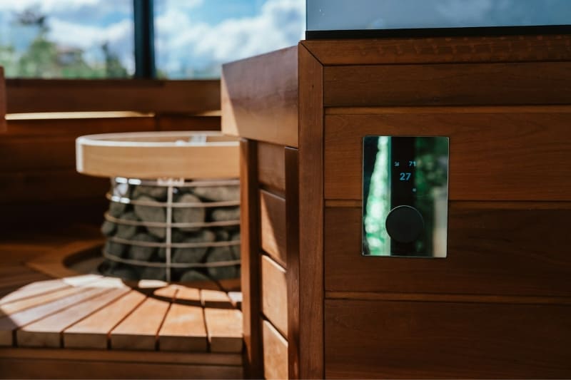 Interior of wooden sauna with digital temperature display