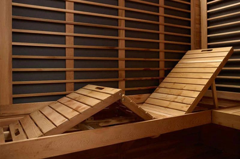 Inside an infrared sauna with adjustable reclining wooden benches