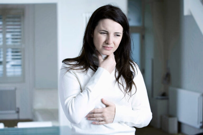 Woman experiencing painful sore throat symptoms and discomfort