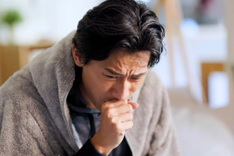 Man suffering from persistent dry cough and respiratory discomfort