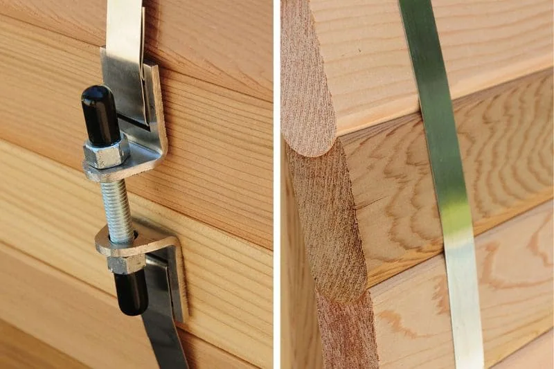 Detailed view of barrel sauna construction hardware showing metal bands, mounting brackets, and wood joinery techniques