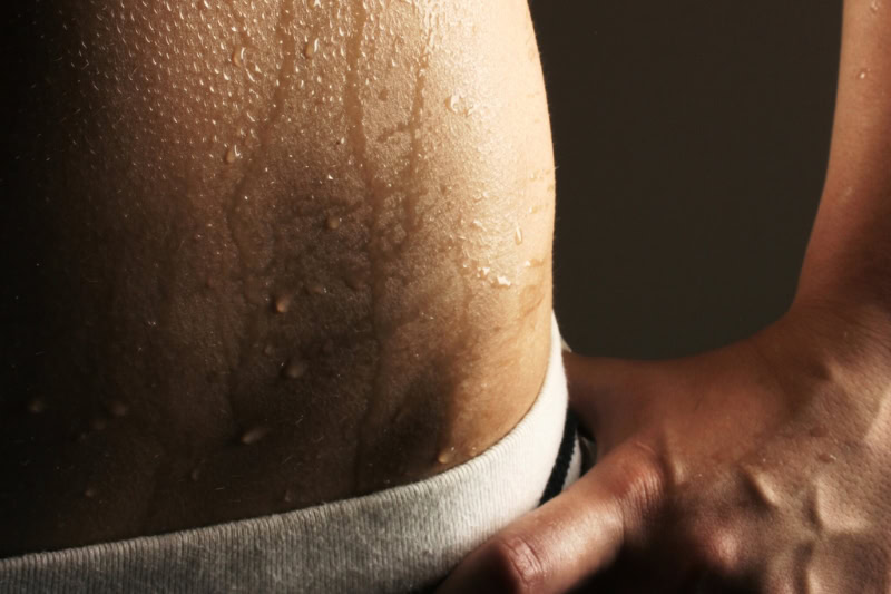 Beads of sweat on skin during therapeutic heat exposure showing natural bodily response