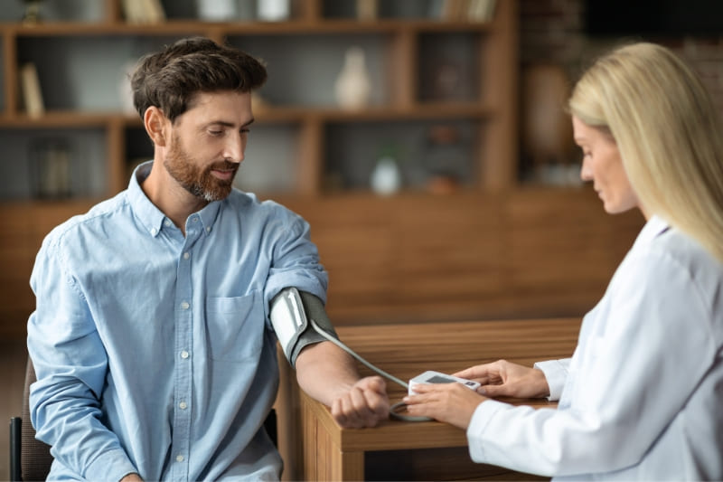 Healthcare professional measuring patient's blood pressure