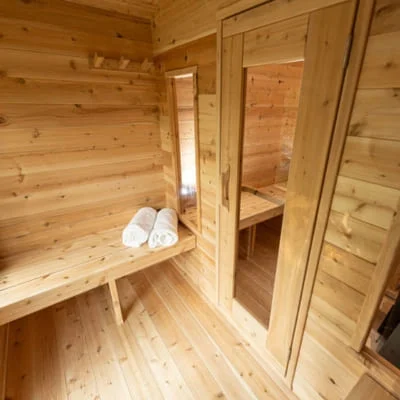 Interior view of Dundalk CT Georgian sauna changeroom with cedar benches and towel storage