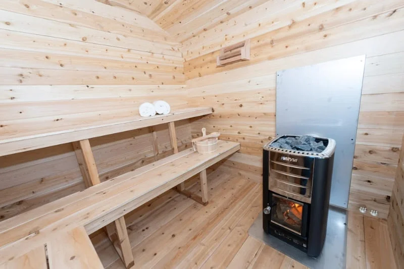 Interior of Dundalk sauna showing wooden benches and Harvia heater installation