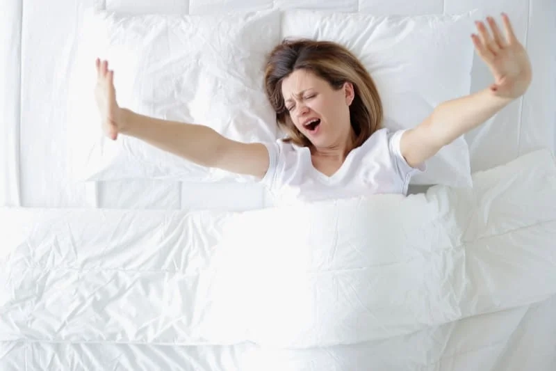 Woman experiencing better sleep quality after a sauna session