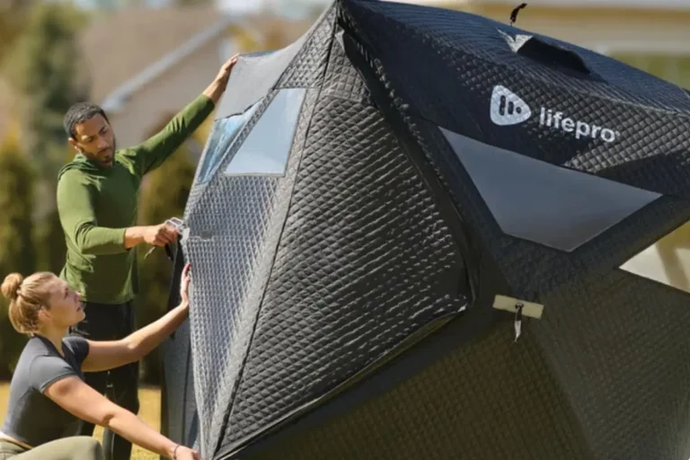 Two people setting up the LifePro ZenZone portable outdoor sauna tent showing the easy assembly process