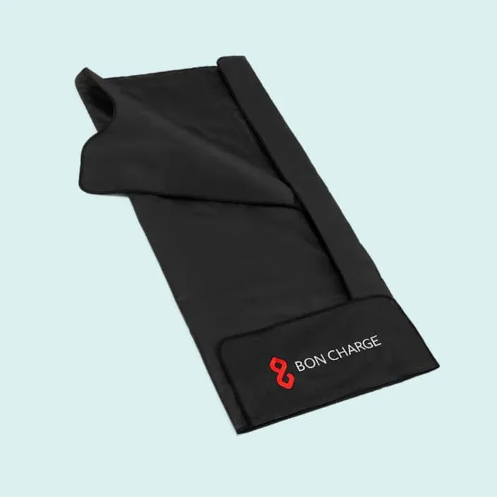 The BON CHARGE infrared sauna blanket in red against a blue background