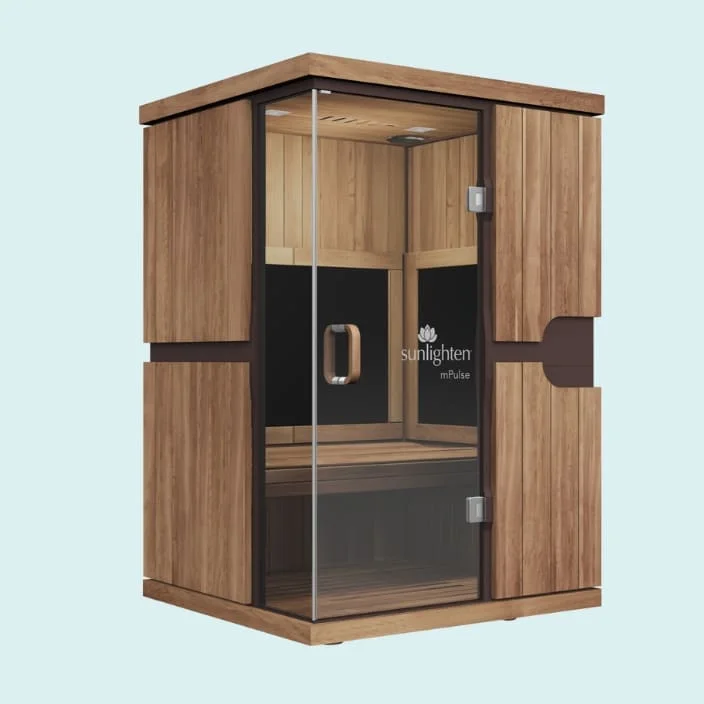 Sunlighten mPulse Believe infrared sauna with full glass front door, wooden exterior in eucalyptus finish, digital control panel, and bench seating, shown from a three-quarter view perspective against a blue background