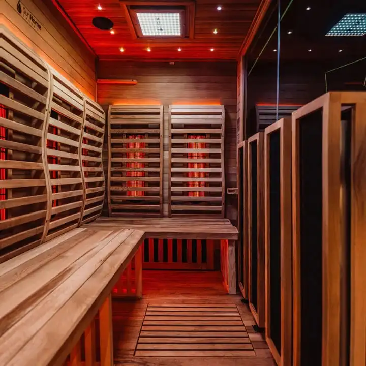 Sun Home Luminar 5-person home infrared sauna interior showcasing red chromotherapy, carbon heating elements, and spacious cabin design for therapeutic sessions.