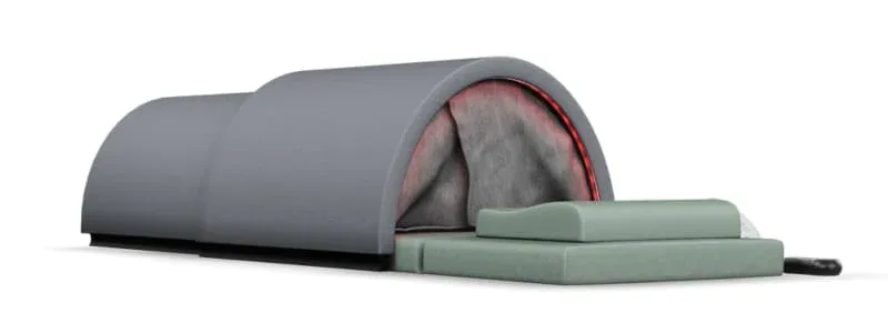 Sunlighten Solo portable infrared sauna with dome closed and mint green memory foam pad, showcasing its sleek design and compact form factor.