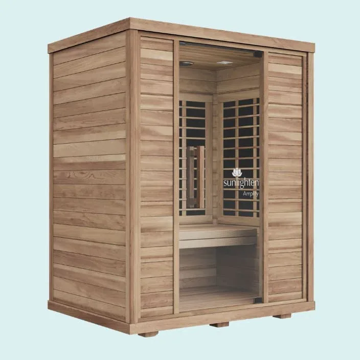 Sunlighten Amplify II 2-person full spectrum infrared sauna with a blue background
