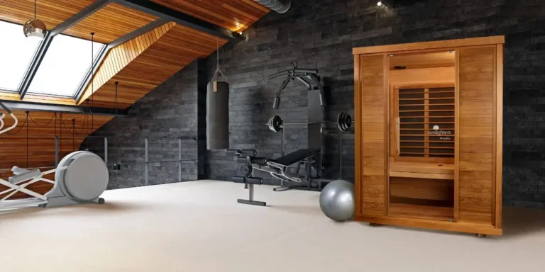 Sunlighten Amplify full spectrum infrared sauna in modern home gym with wooden ceiling, exercise equipment, and stone accent wall
