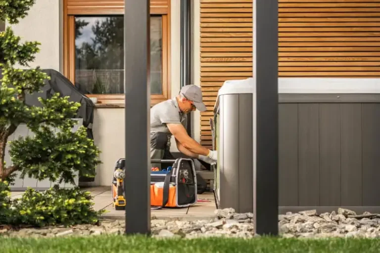 Professional hot tub removal service technician dismantling spa equipment in residential backyard setting