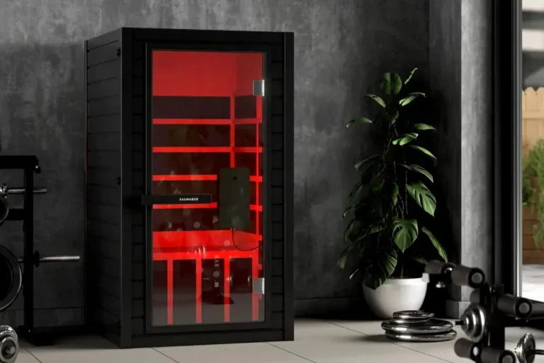SaunaBox Solara full-spectrum infrared sauna with red light therapy in a modern home gym setting